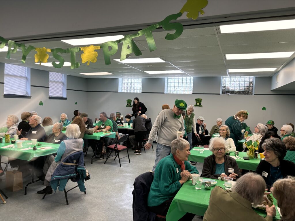 On
March 16 th , Croton Caring welcomed 75 Croton seniors to its annual St. Patrick’s at the Village
Community Room. Attendees were treated to a complete St. Patrick’s Day meal including
corned beef and cabbage donated by Dino Tsagarakis and the Croton Colonial Diner and soda
bread and a themed cake provided by ShopRite. Decorative centerpieces were prepared by Girl
Scout Troop 1233 and festive music was provided by regulars Len Franco and Don Simons.